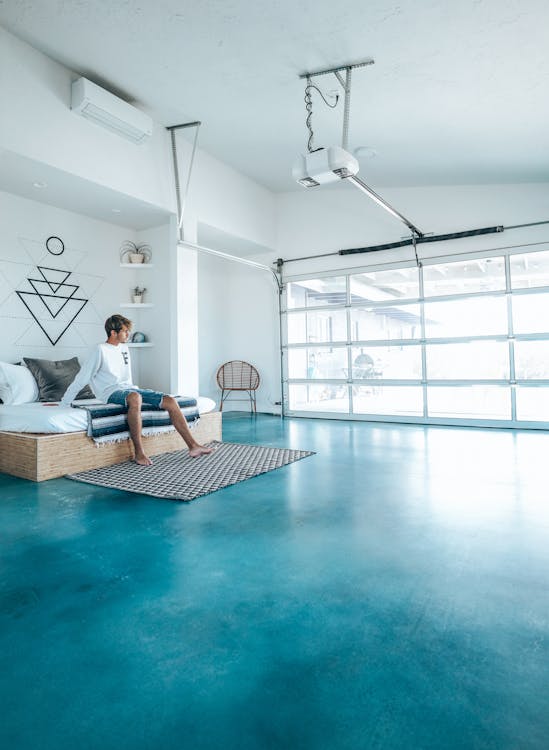 Man in Bedroom with Blue Floor 