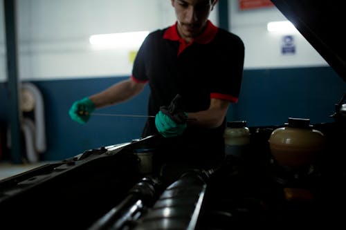 Free Man Checking the Engine Oil Stock Photo