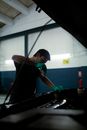 Man in Black T-shirt Holding Green and Black Metal Rod