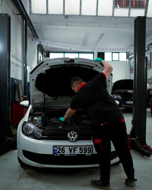 Free Man Checking the Engine of a Car Stock Photo