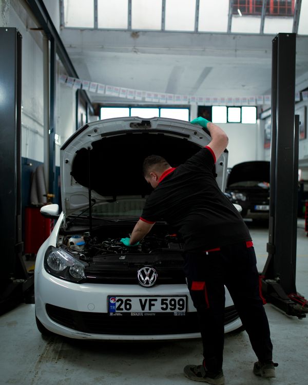 Technician using a laptop for vehicle diagnostics