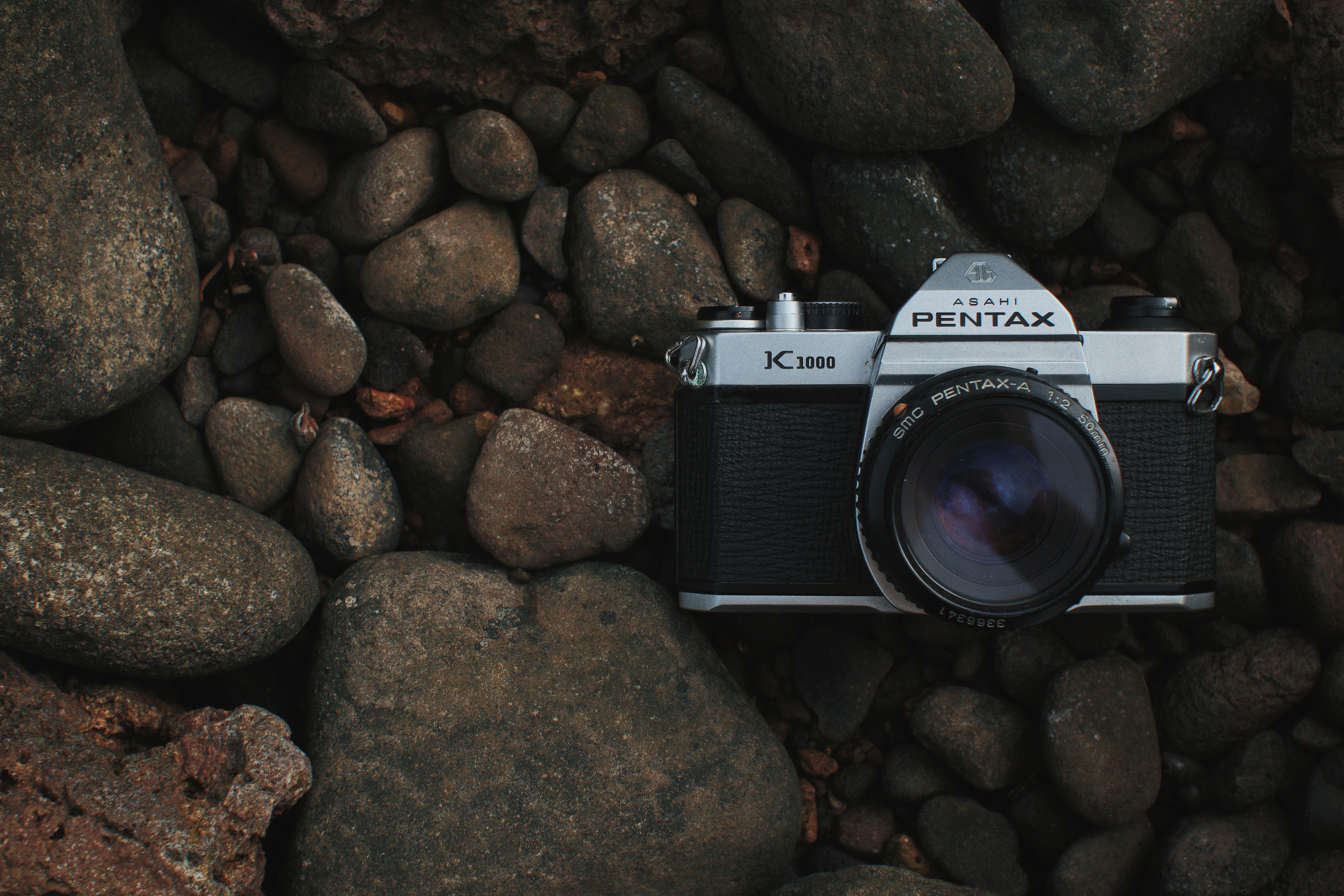Close-Up Shot of a Black Camera on top of Rocks · Free Stock Photo