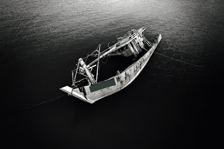 A Grayscale Of A Sinking Fishing Boat