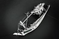 Grayscale Photo of a Sinking Ship