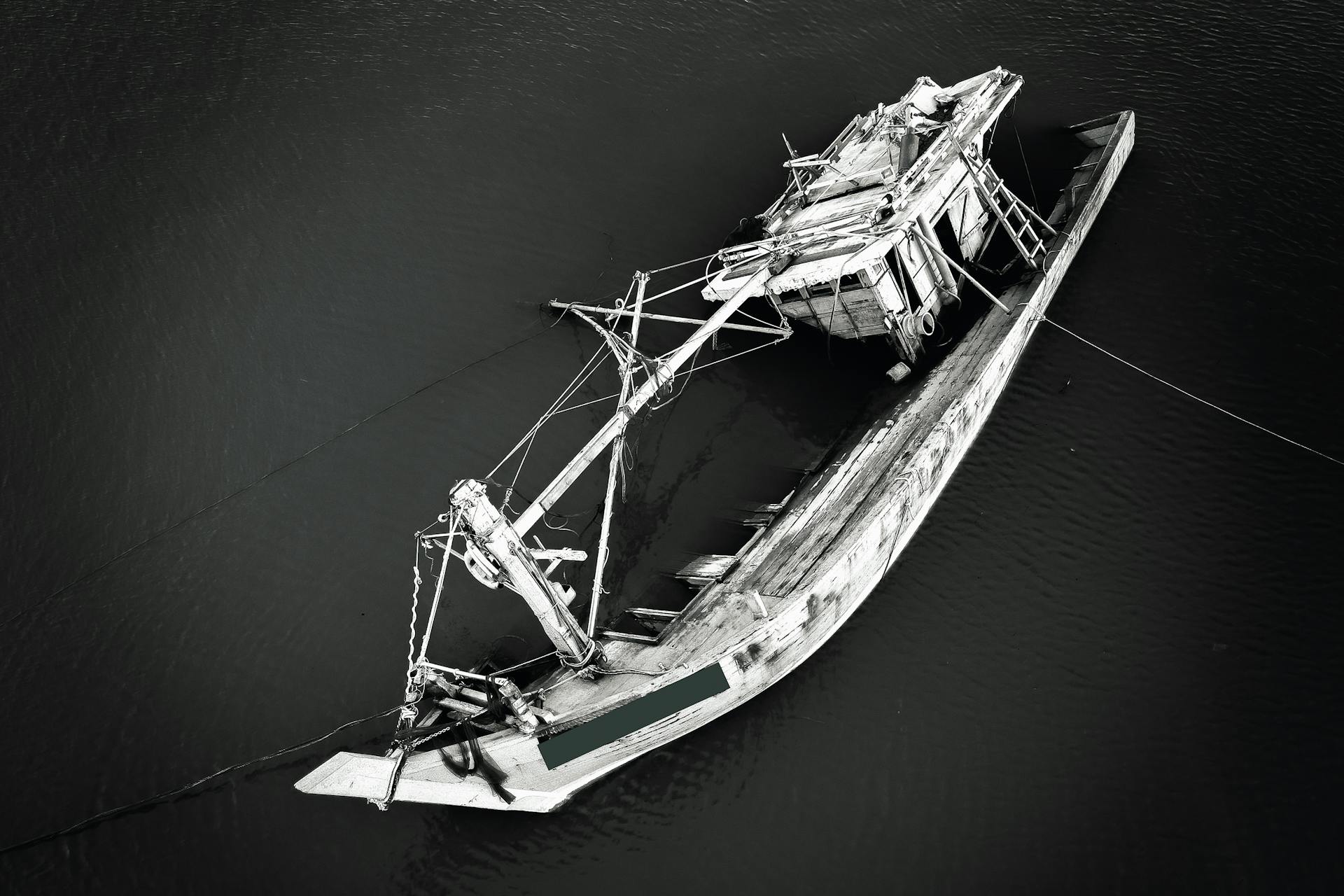 Grayscale Photo of a Sinking Ship