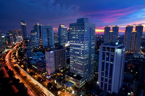 Free Vibrant cityscape showcasing skyscrapers against a colorful twilight sky. Stock Photo