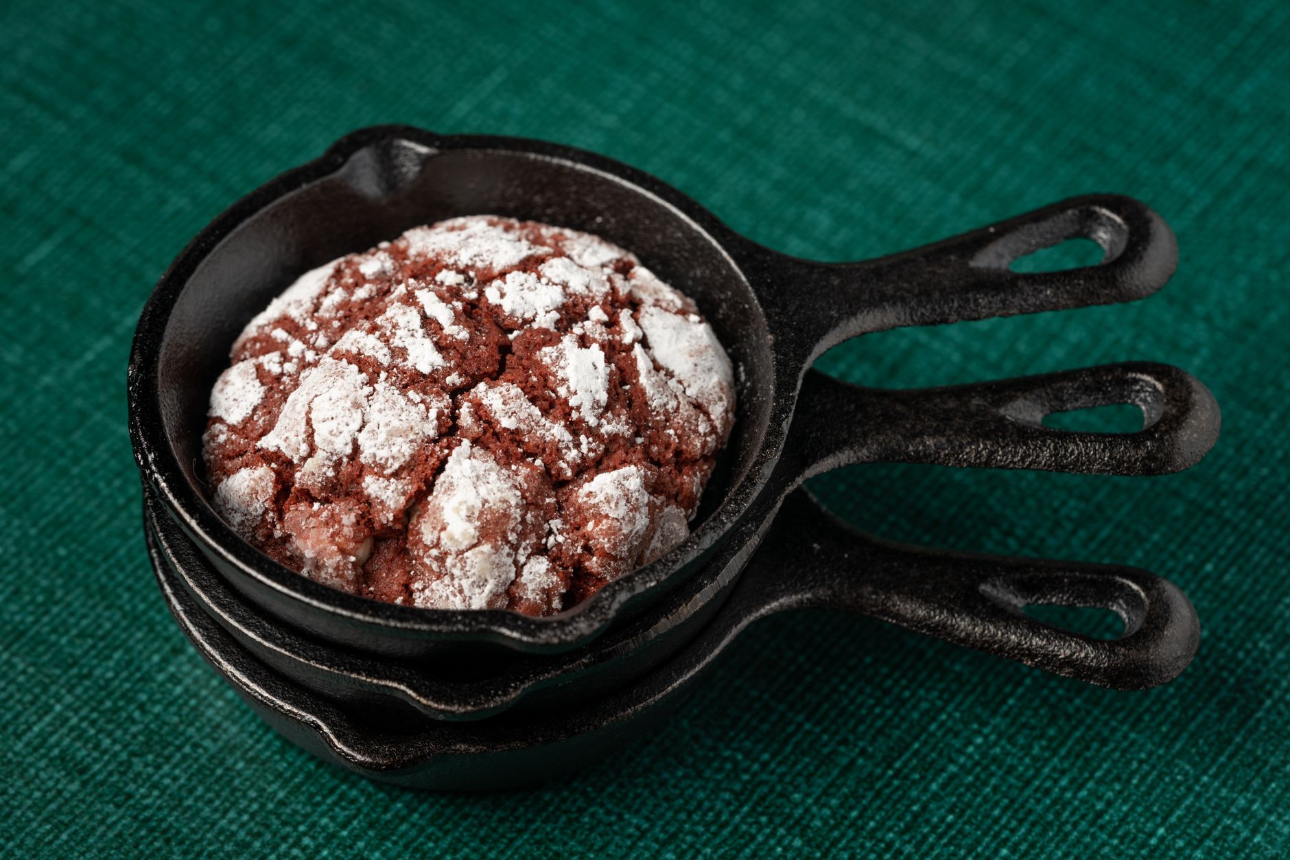 Mini cocotte dessert garnished with fresh berries and a dusting of powdered sugar