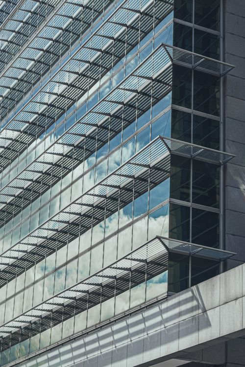Free Reflective glass facade of a modern office building with sky reflections in Bogotá, Colombia. Stock Photo