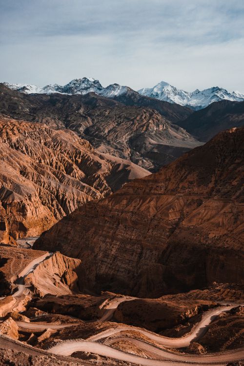 Free A breathtaking view of rugged mountains under a blue sky, perfect for nature and travel enthusiasts. Stock Photo