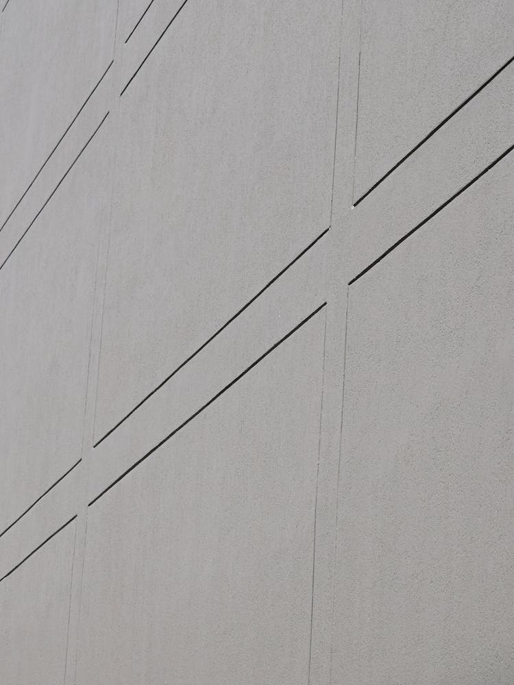 A Gray Concrete Wall With Lines Pattern