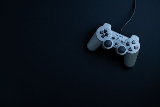 A top-down view of a classic game controller on a dark surface, ideal for gaming themes.