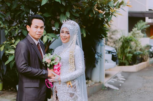 Man and Woman in Wedding Suit and Dress