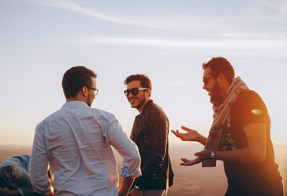 Free Three Men Standing While Laughing Stock Photo