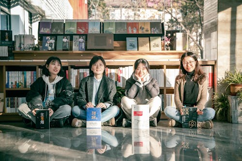 Women Sitting on the Floor Inside the Book Store