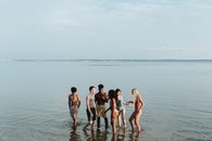 3 Men and 2 Women Standing on Sea Shore