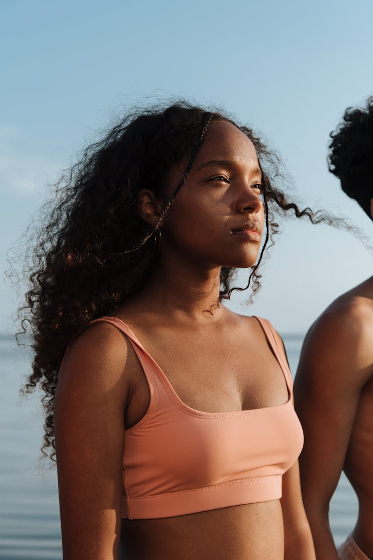 Girl With Curly Hair At Seaside With Wind In Hair