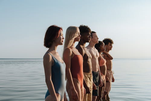 Teenagers Standing in Water in Row