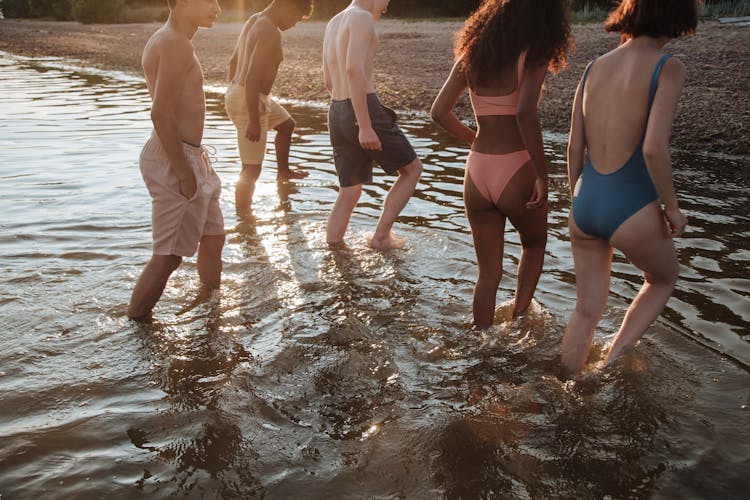 Teenagers Walking Out Of Water