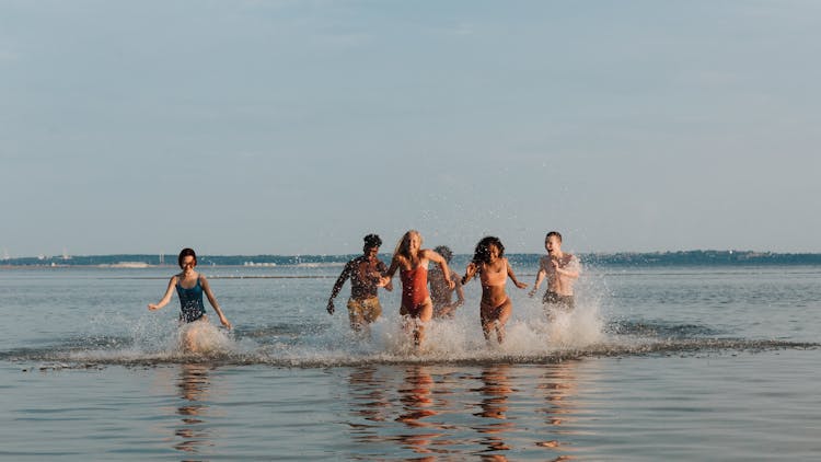 Teenage Friends Running Through Water