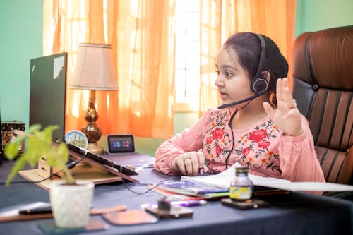 Girl With Headset Using Laptop 