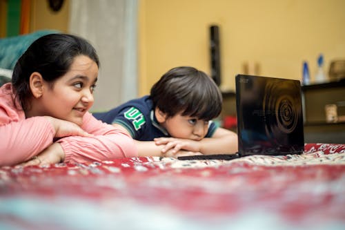 Close-Up Shot of Kids Watching Using a Laptop