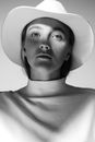 Black and White Portrait of Woman with Hat Casting Shadow on her Face