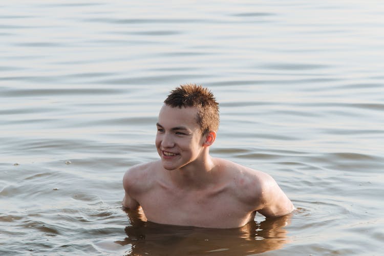 Teenage Boy Swimming In Sea