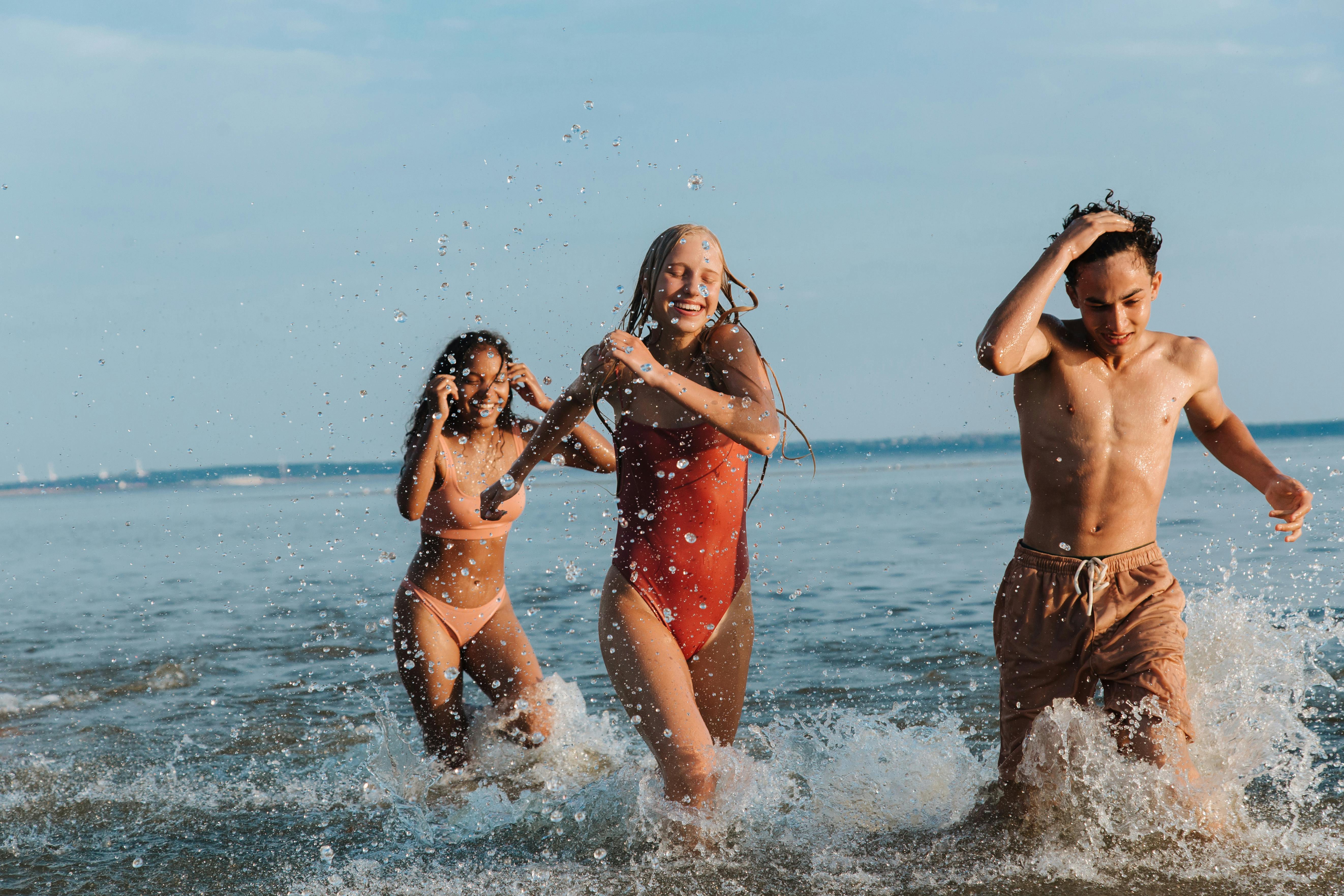 Teenage Friends Playing in Sea · Free Stock Photo