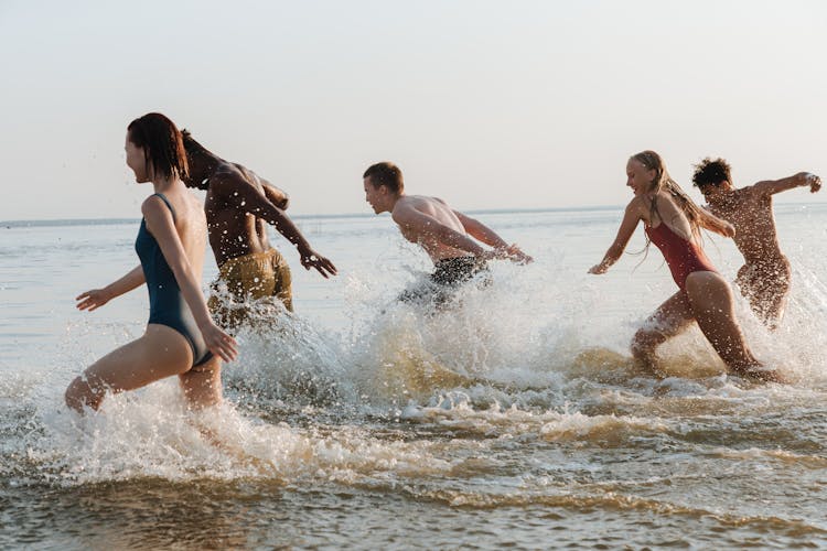 Boys And Girls Running In Sea