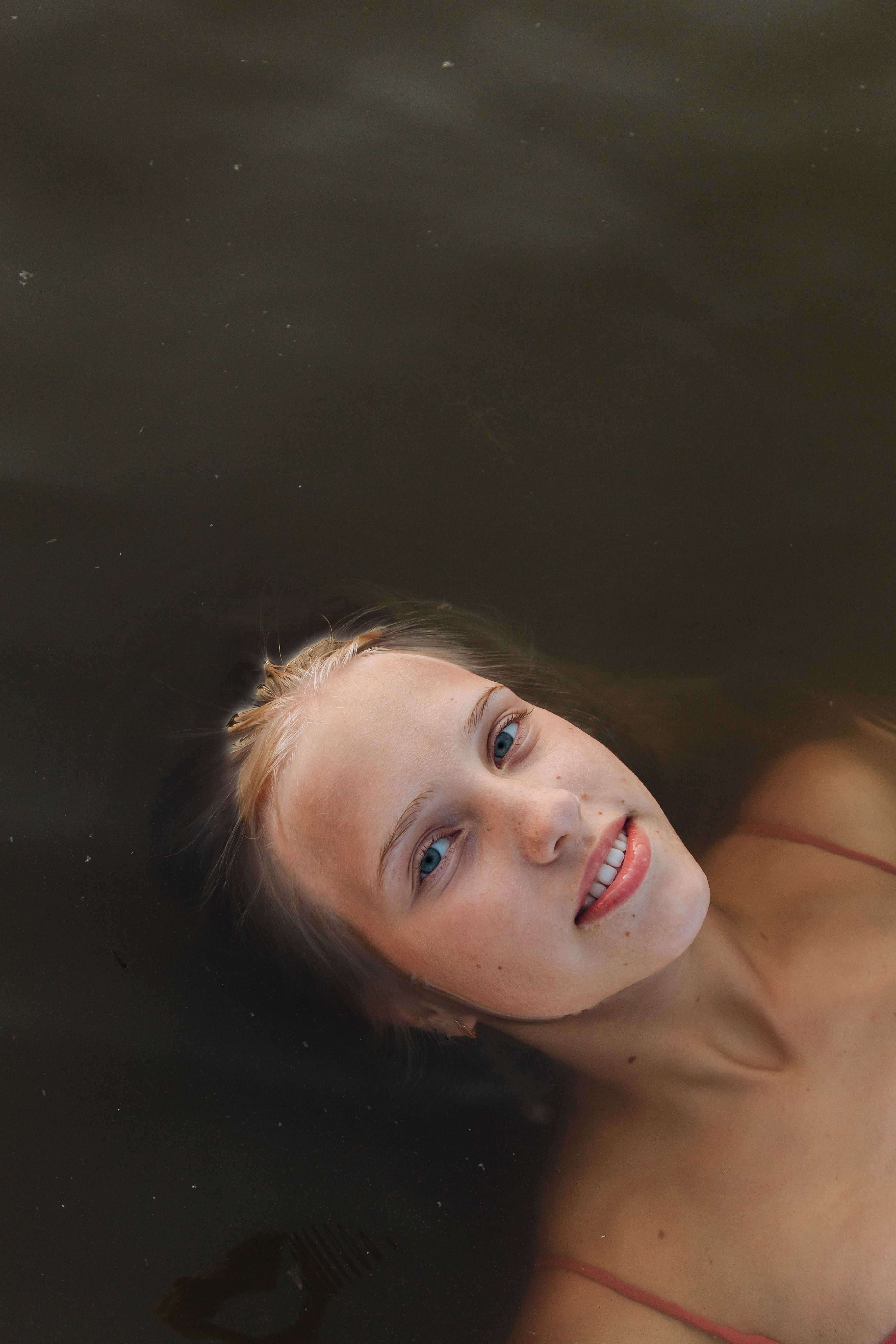 Teenage Girl Lying in Water · Free Stock Photo