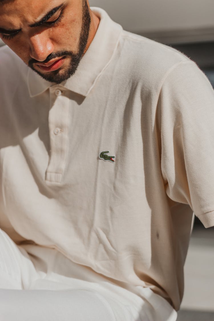 A Man Wearing A Lacoste Polo Shirt