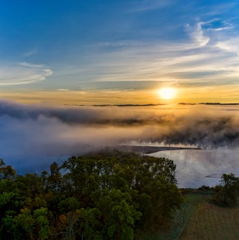 Breathtaking sunrise over a fog-covered lake in Ella, Wisconsin, captured from above.