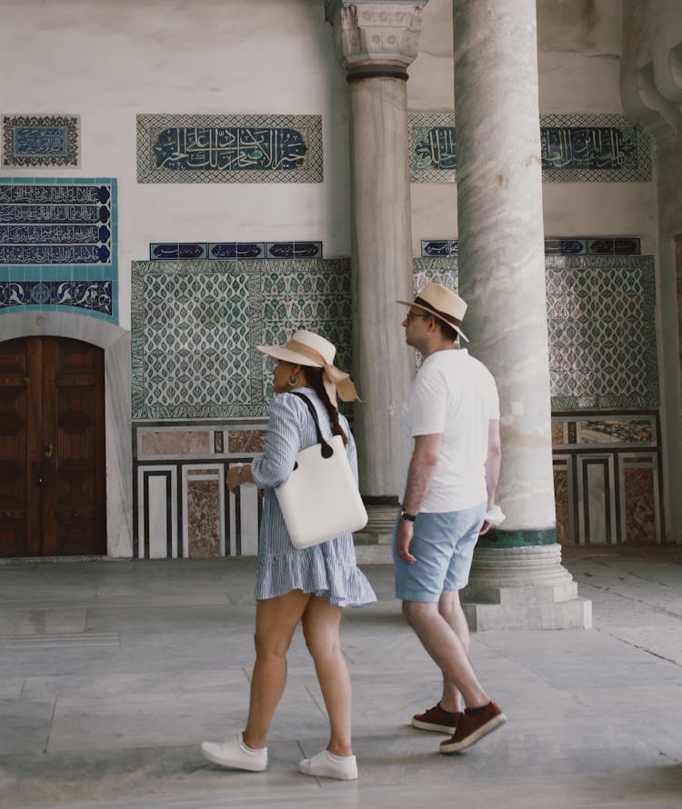 Tourist Couple Walking Inside A Building