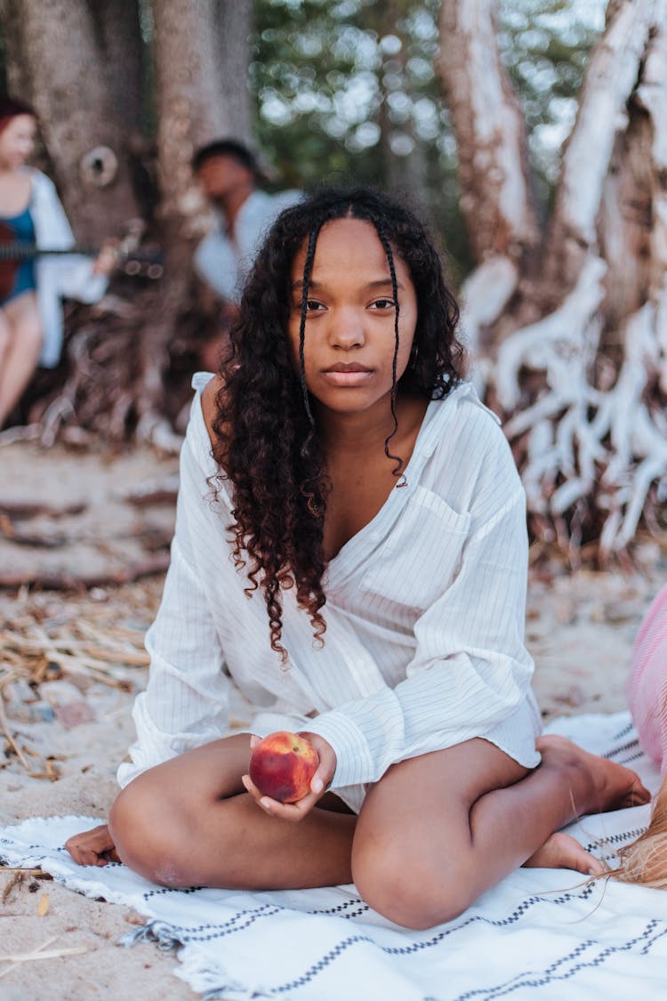 Girl On The Blanket Holding A Peach