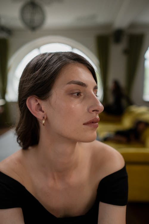 Woman in Black Dress Looking Sideways