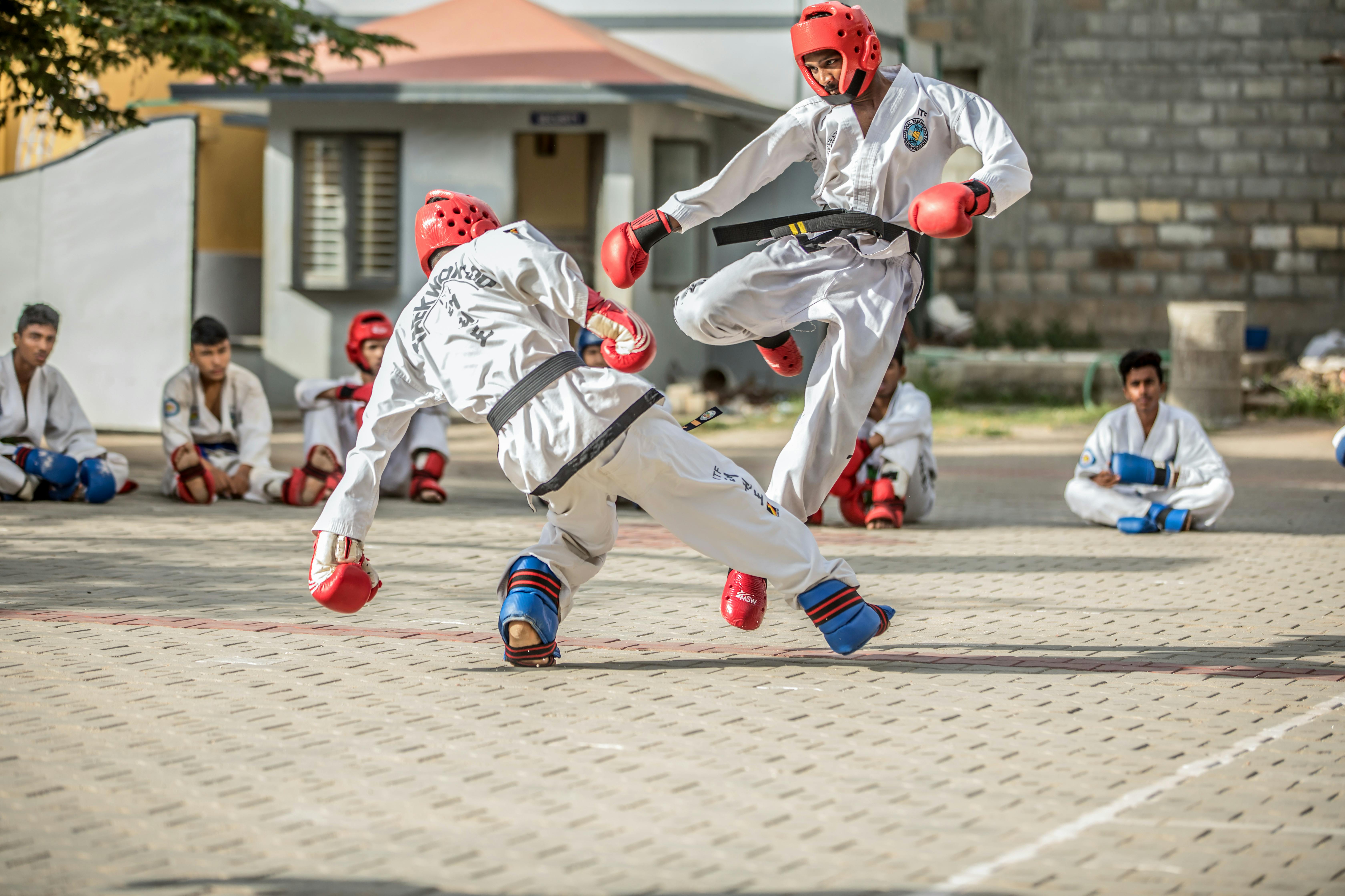 Taekwondo Practitioners In A Sparring Match · Free Stock Photo