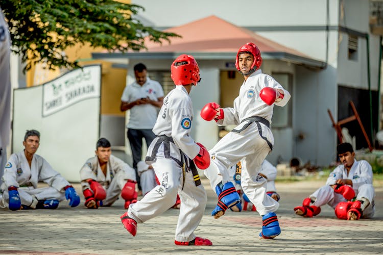 Taekwondo Athletes Sparring With Protective Gears