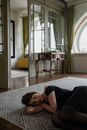 Woman in Black Tank Top Lying on Floor