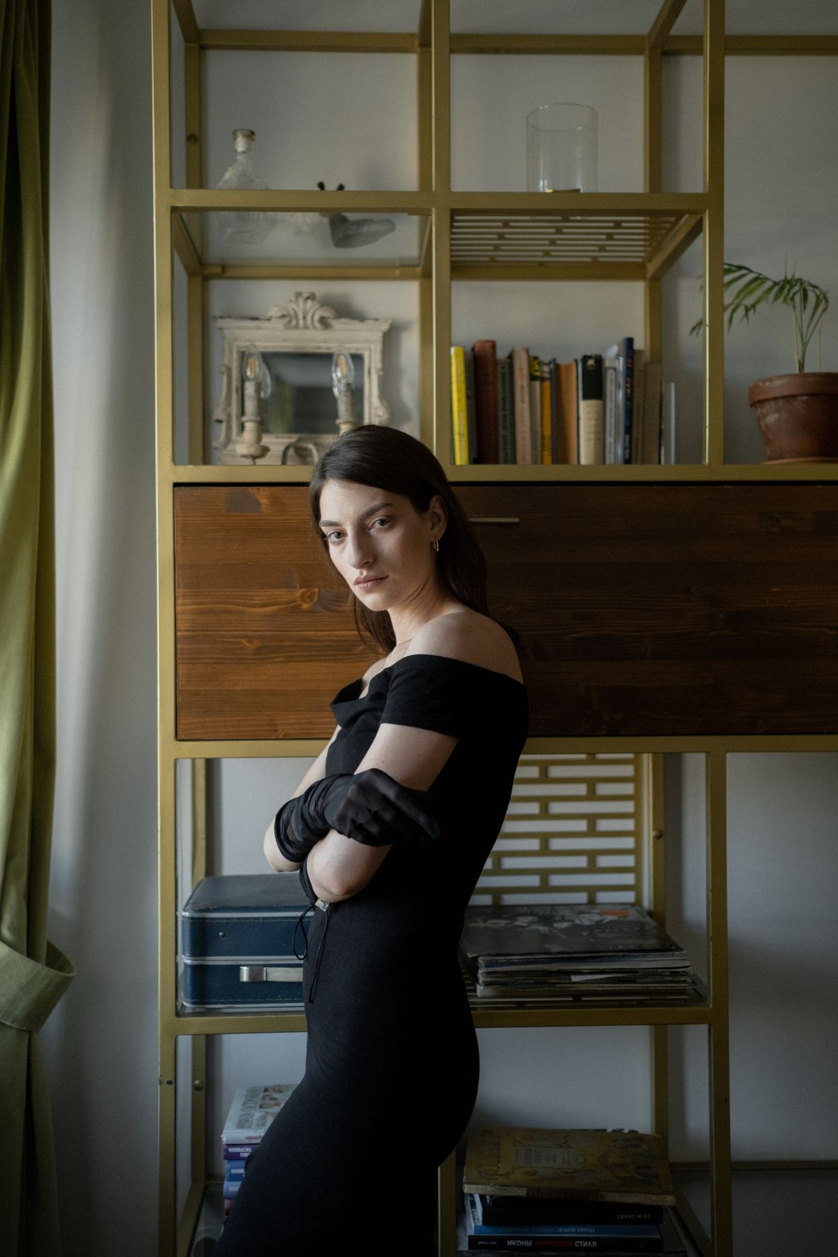 A woman in a black off-shoulder dress and gloves — old-world glamour