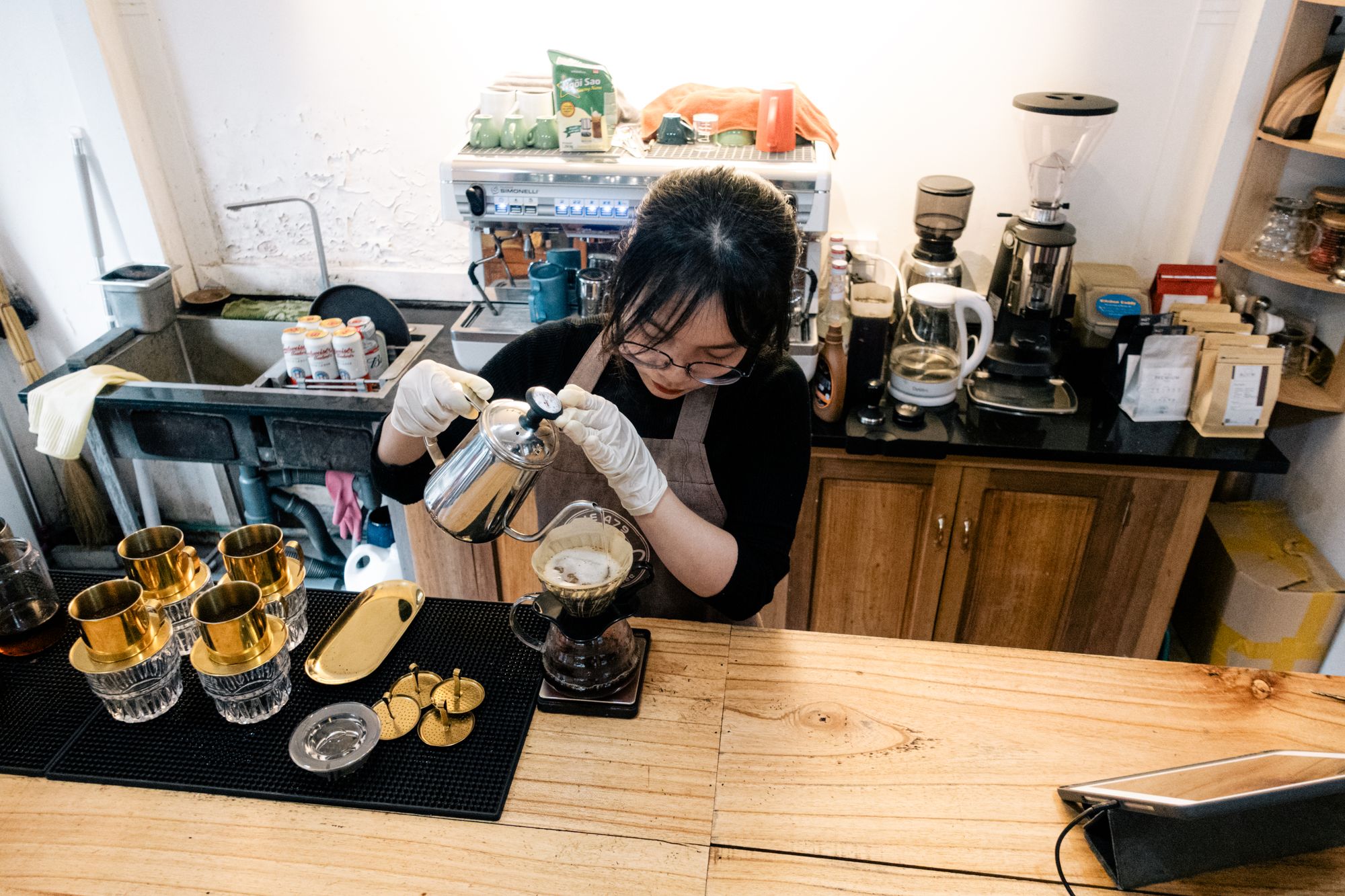 A barista making drip coffee