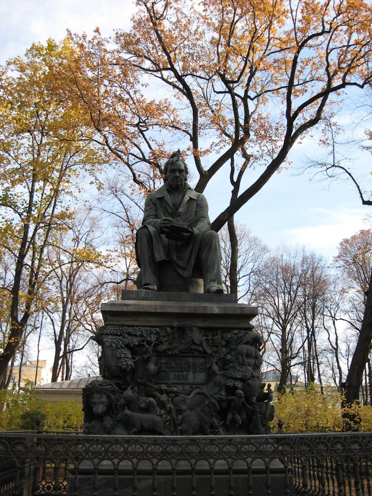 Ivan Krylov Statue On The Background Of Autumn Trees