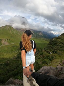 A woman leads the way on a mountain trail in Trentino-South Tyrol, Italy.