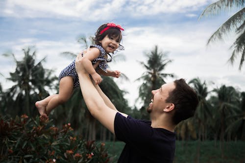 Man Laughing While Lifting a Girl