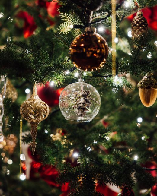 Decorative Christmas tree with glass ornaments and festive lights.