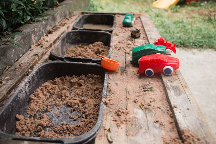 Basins With Sand And Toy Cars