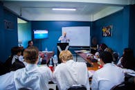 People Sitting on Chair in Front of Table