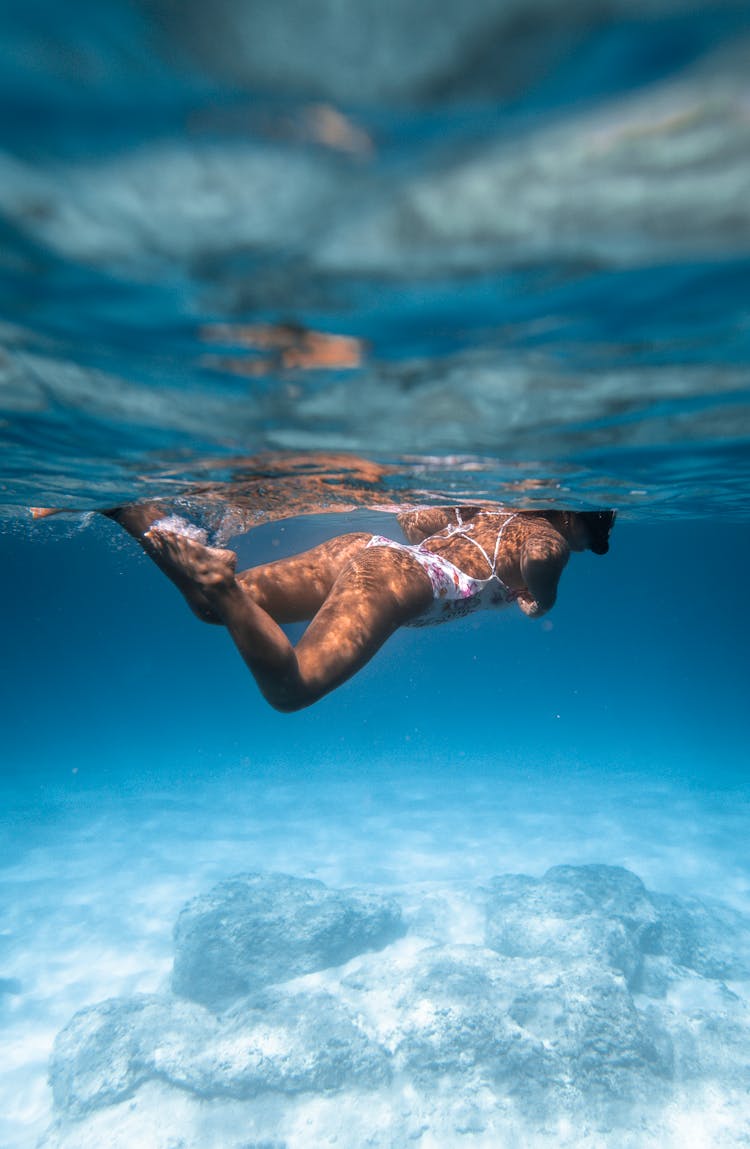 Woman Diving Near Sea Bottom