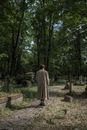 Back View of a Man Walking in a Graveyard
