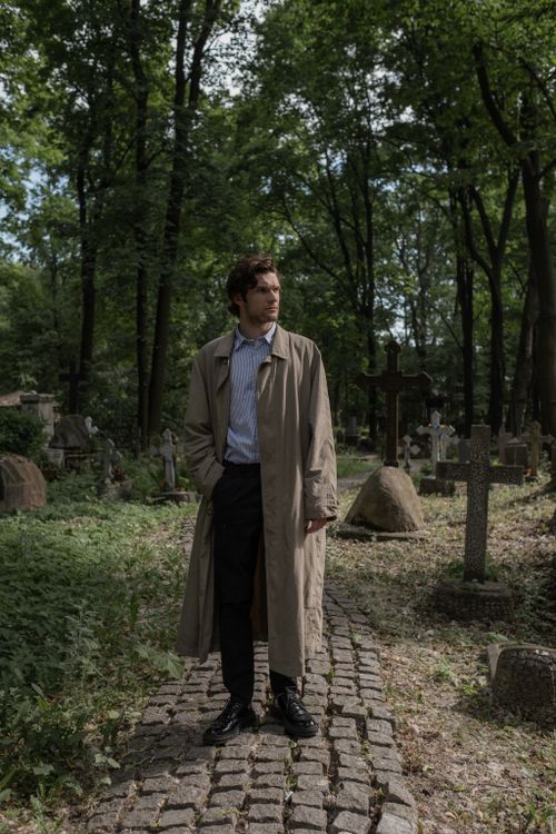 A Man in a Trench Coat Standing in a Graveyard · Free Stock Photo