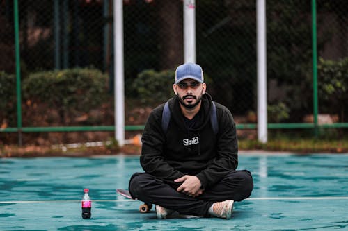 Man Sitting on Wet Court